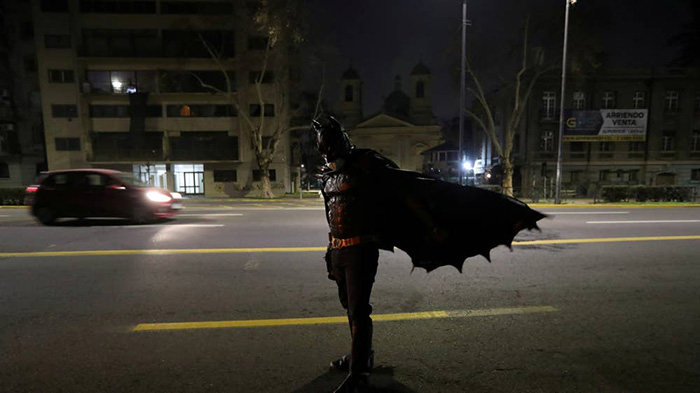 In Santiago, Batman is delivering meals to the homeless people